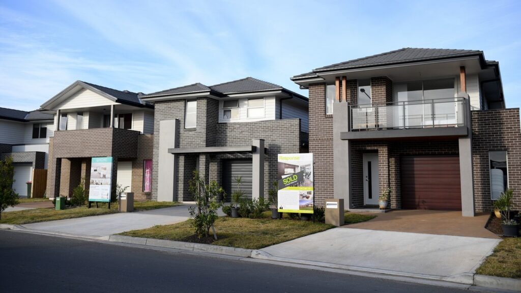 Building cost estimator reviewing construction plans and quantity takeoff